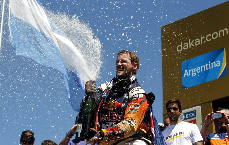 KTM motorcycle rider Price of Australia celebrates with champagne at the podium after he won the Dakar Rally 2016 in Rosario