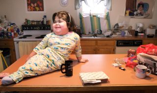 Gregory Rec/Staff Photographer -- Shiloh Pepin laughs with her parents while sitting on a counter in the family's Kennebunkport apartment on Thursday, December 20, 2007. Because of the way her legs are fused together, Shiloh has to lean to one side when she sits up. (Photo by Gregory Rec/Portland Press Herald via Getty Images)